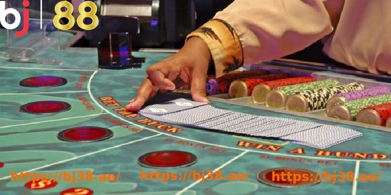 a hand holding a card at a casino